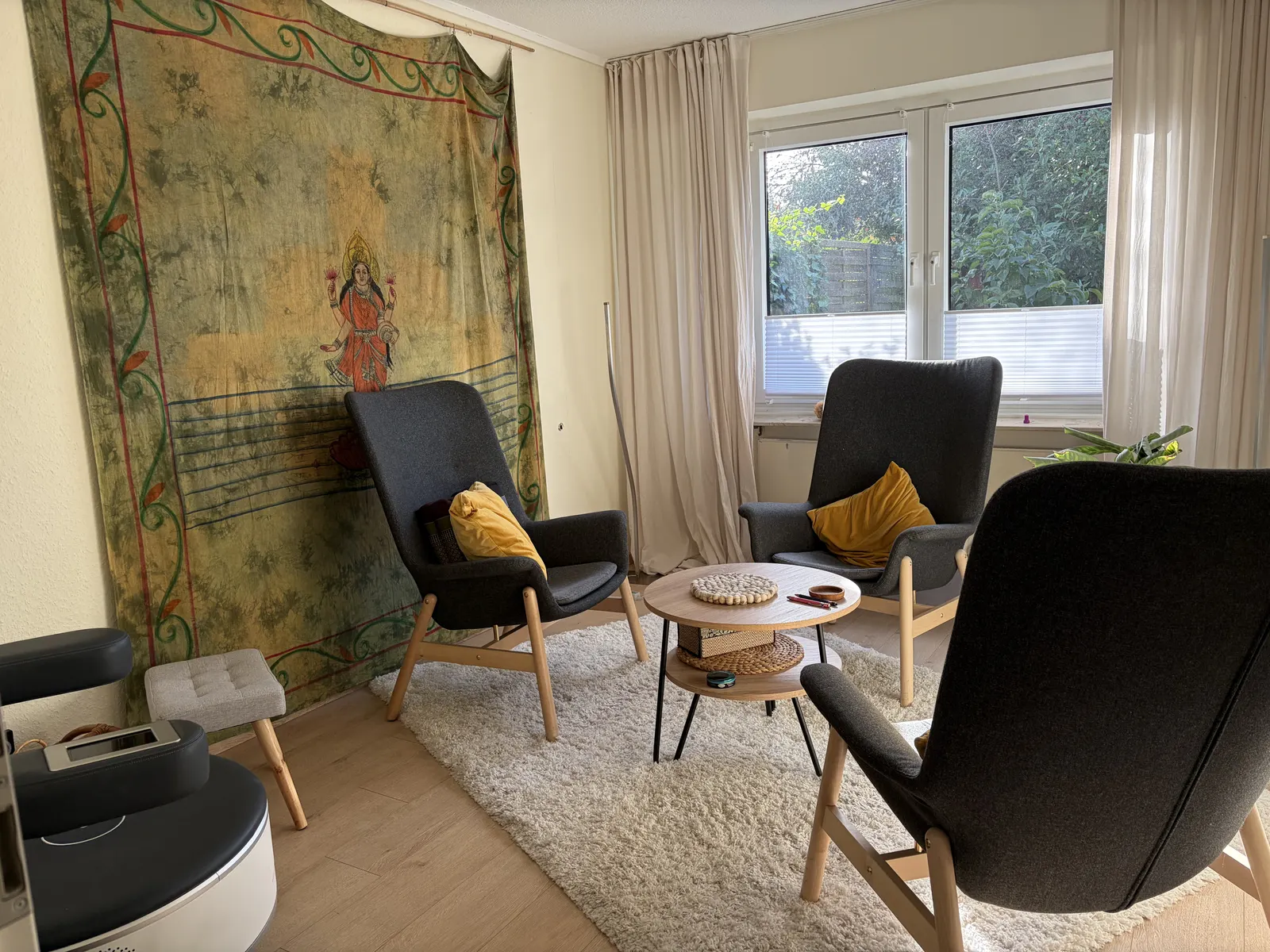 Gesprächsecke mit Sesseln und Wandbehang
